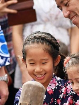 man holding axe beside people